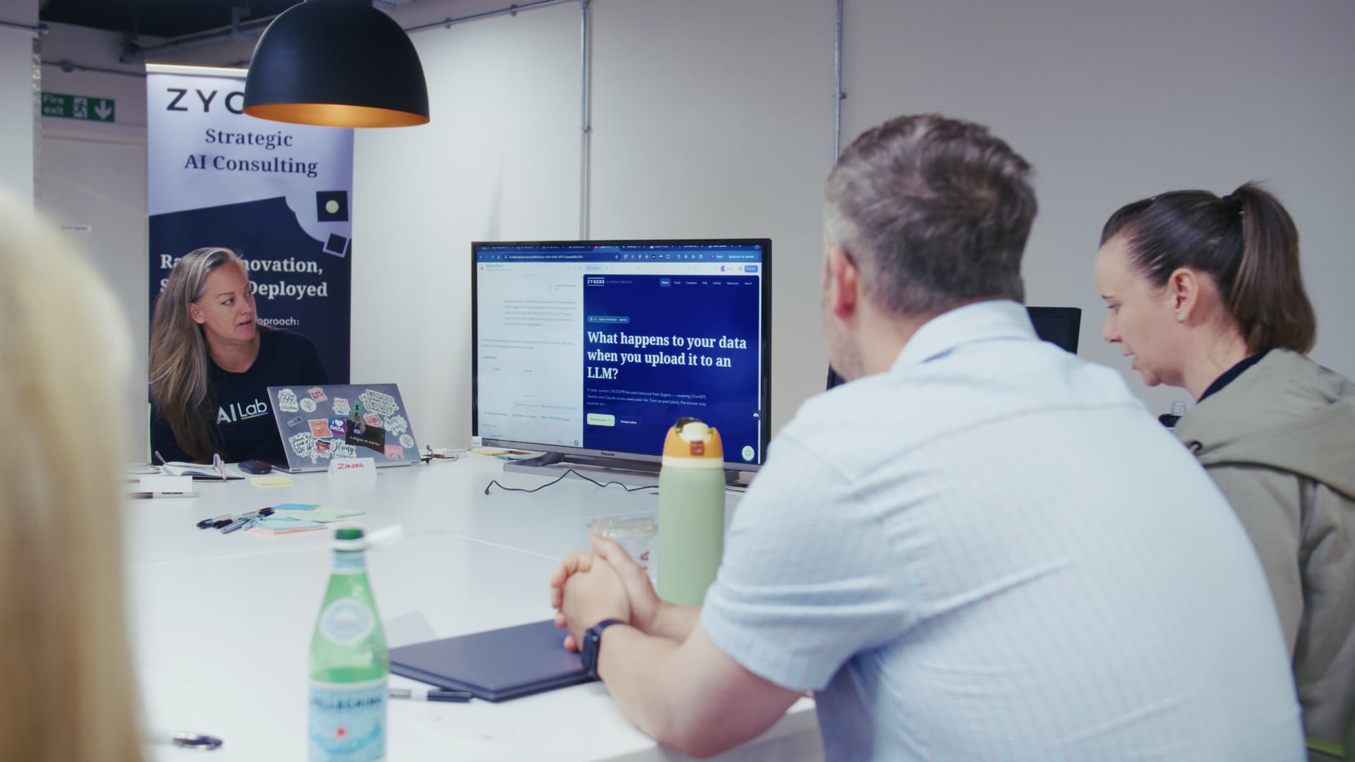 Small group reviewing AI guidance on screen with an AI Lab trainer