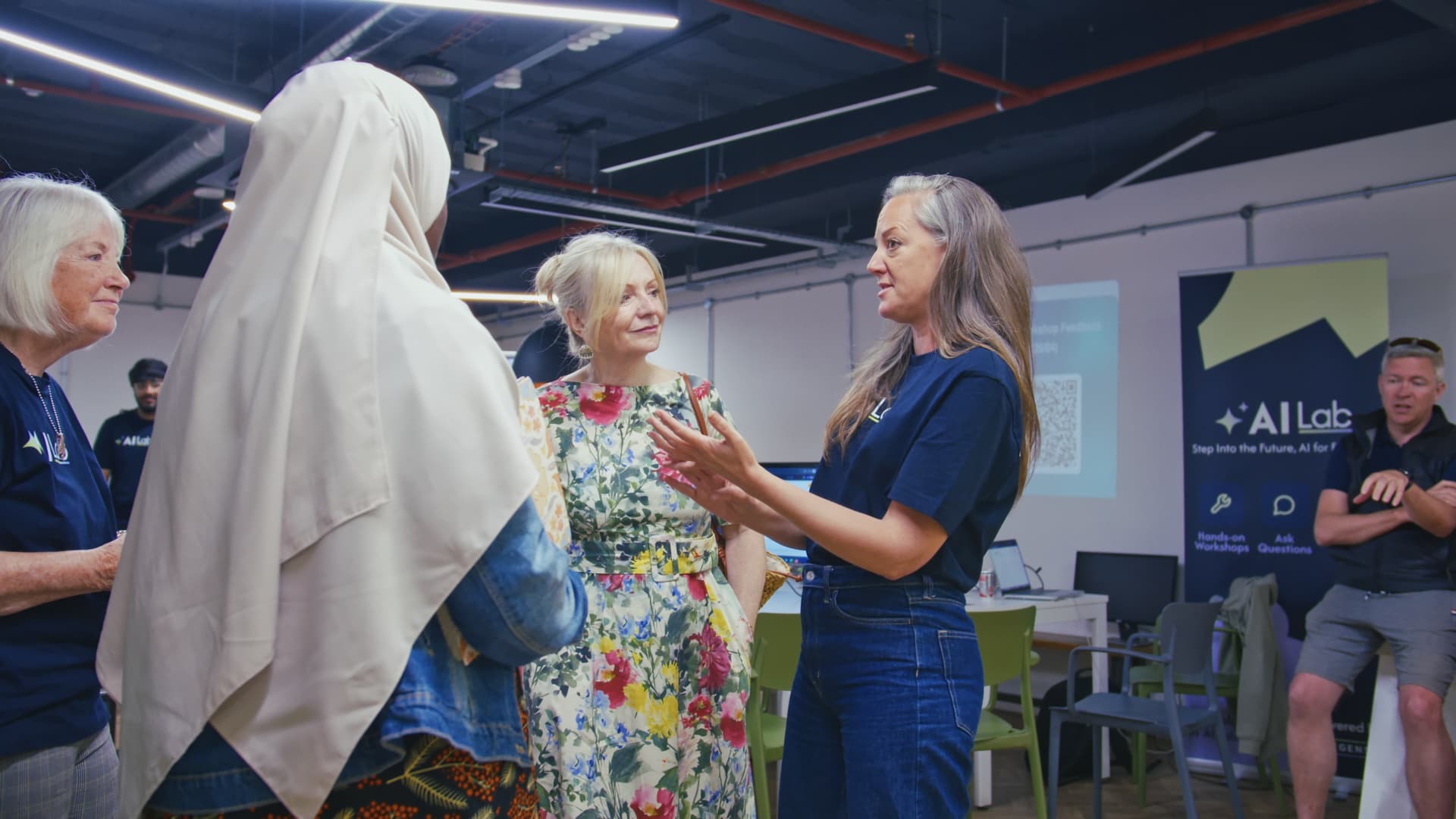 An AI Lab facilitator talking with attendees after a session